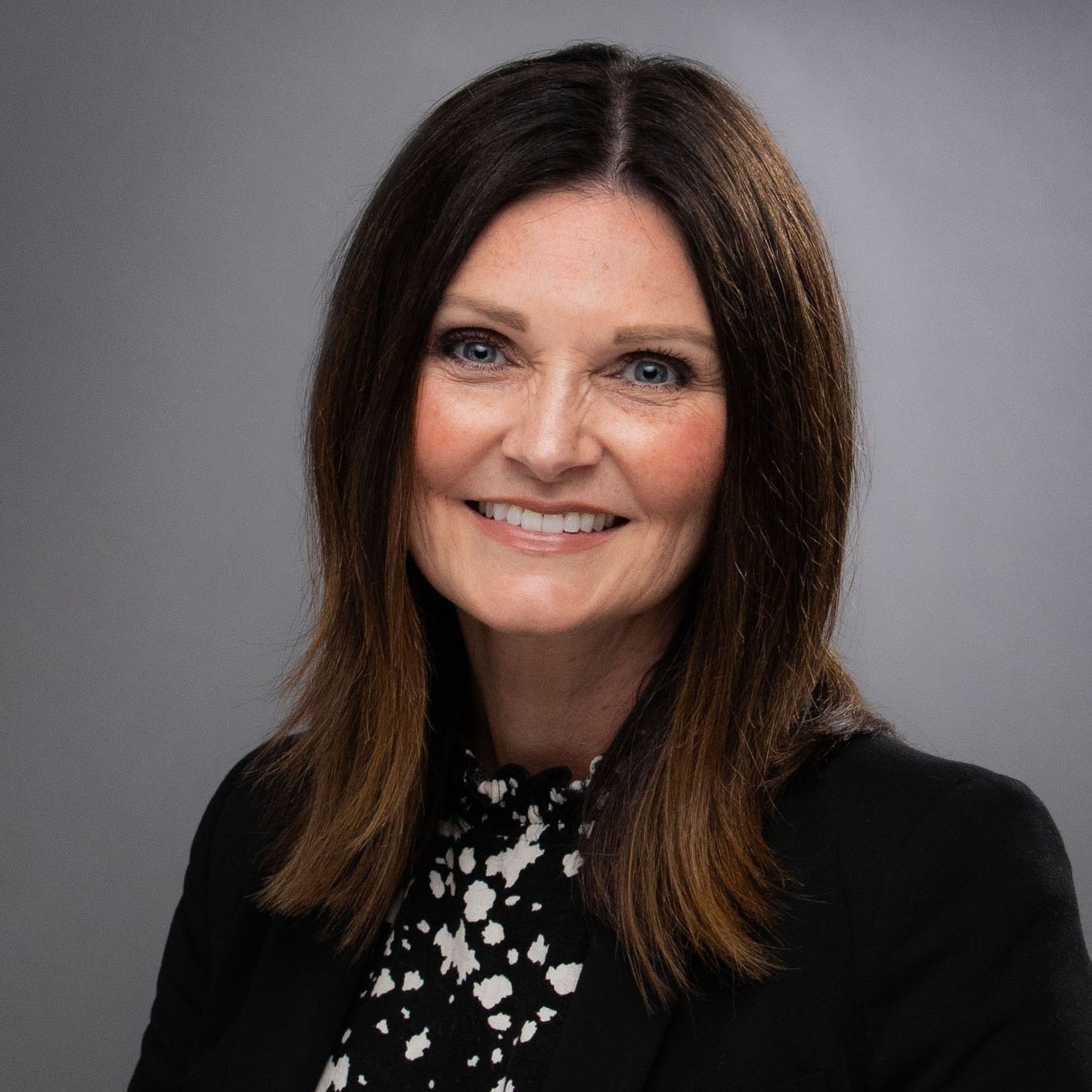 Kendra Stanley-Mills in black jacket, smiling