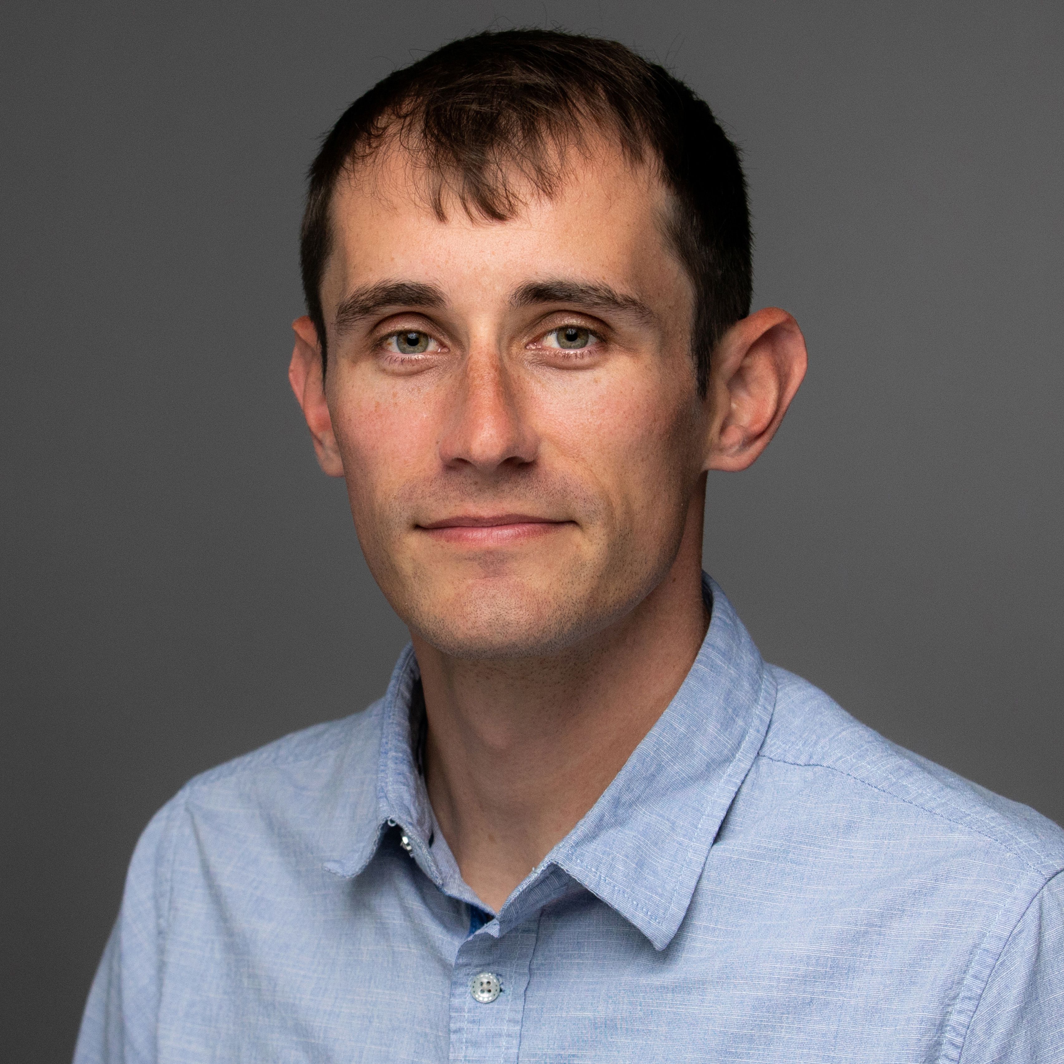 Tony Packer in light shirt smiling