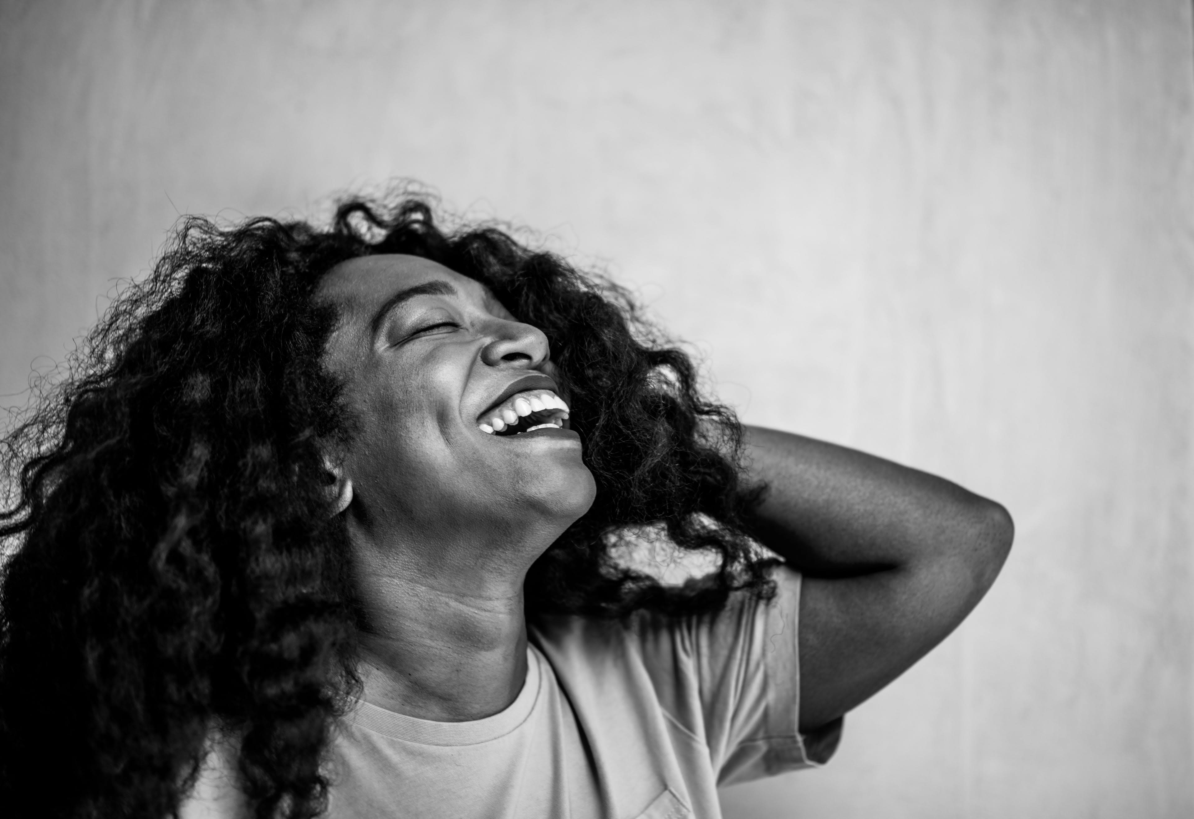 Black and white photo of Andrea Wallace with head back and smiling