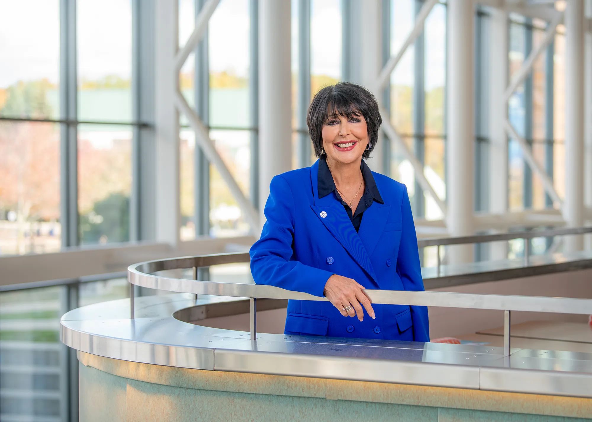 President Philomena V. Mantella in blue jacket and black shirt, smiling