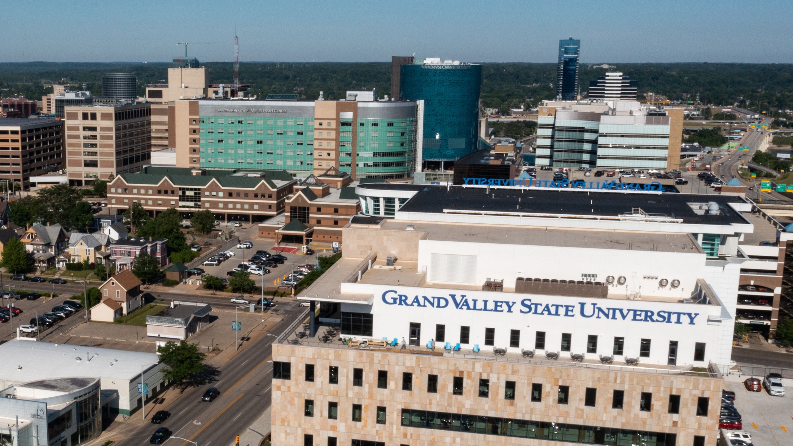 Aerial view of downtown Grand Rapids with Grand Valley State University's health building in the foreground