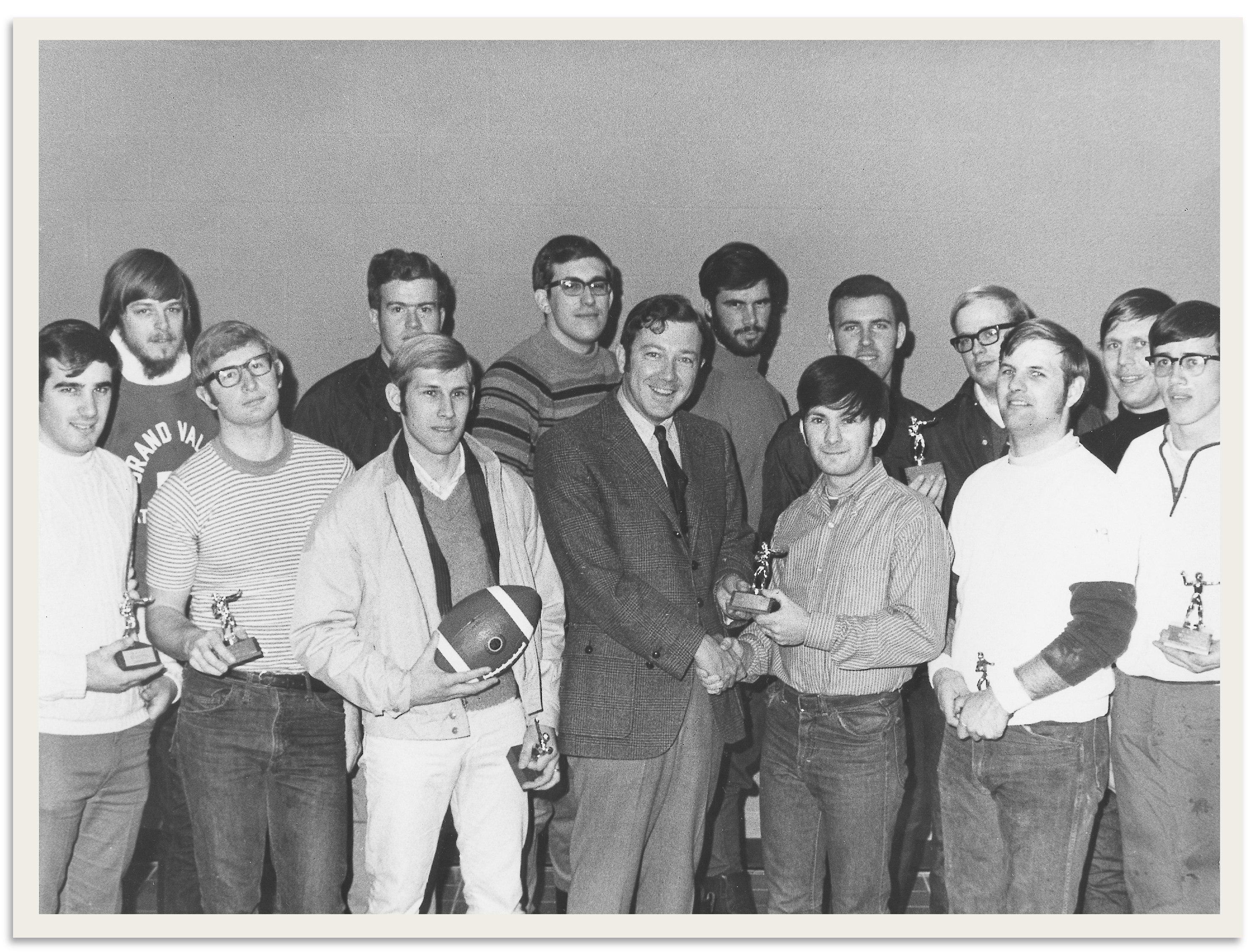President Emeritus Arend D. Lubbers in center with members of the 1970 Laker football team.