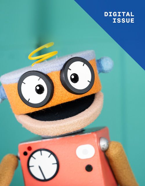 Wimee, a orange robot puppet smiles for the camera on a teal background. Text in the top right reads 'DIGITAL ISSUE'