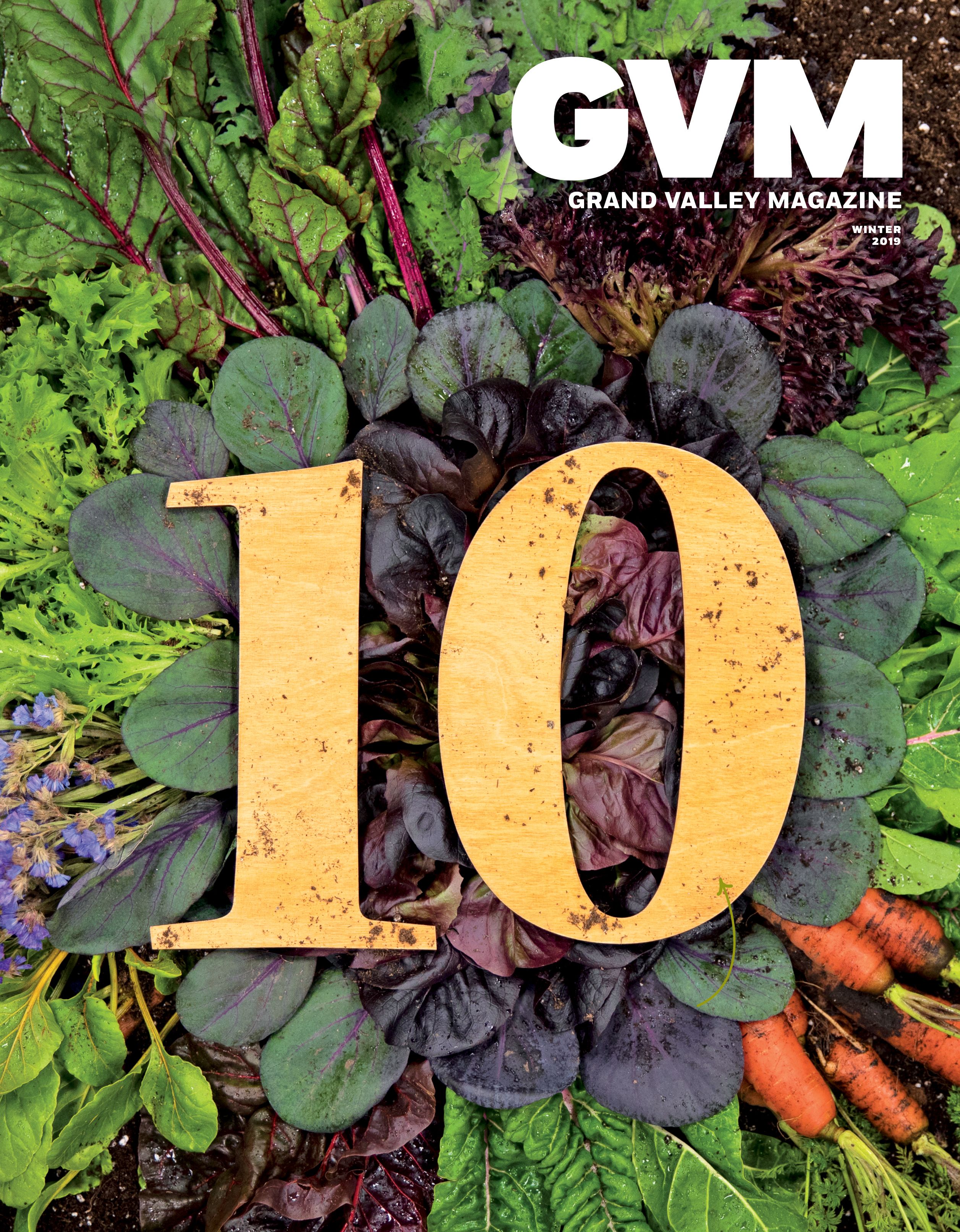 a Number 10 made of wood laying in an arrangement of vegetables.