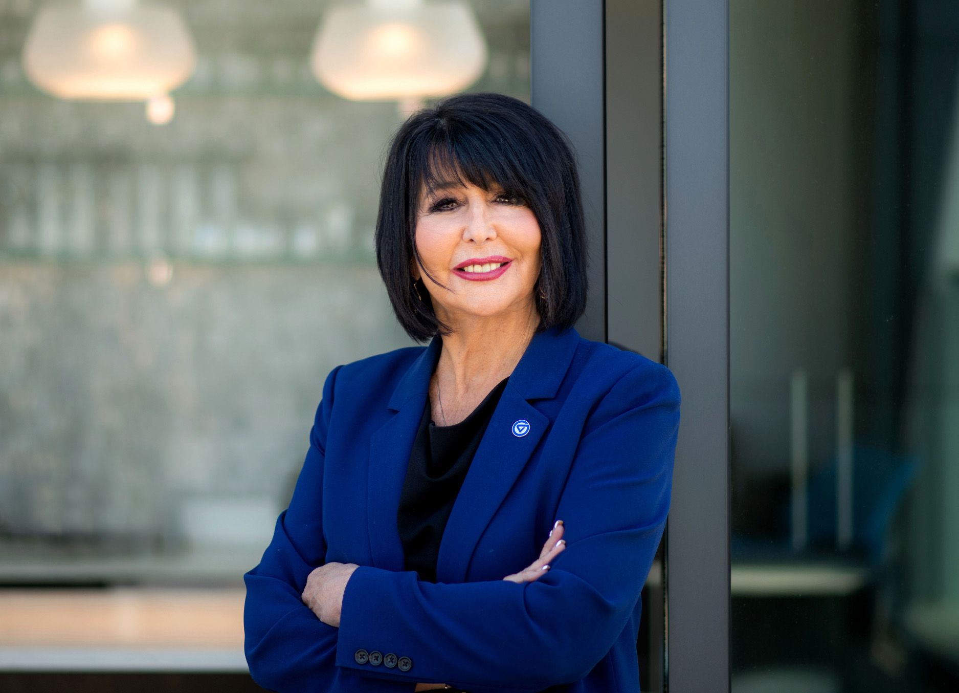 President Mantella in blue jacket, arms crossed