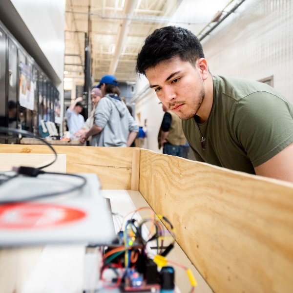 first-year student, Antonio Santos, PDM major, with robot ýMarký