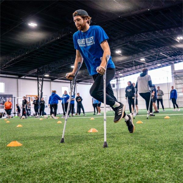 Physical therapy student Caleb Griffith practices mobility with crutches as part of an amputee soccer clinic at the Grand Rapids Soccer Society on February 8.