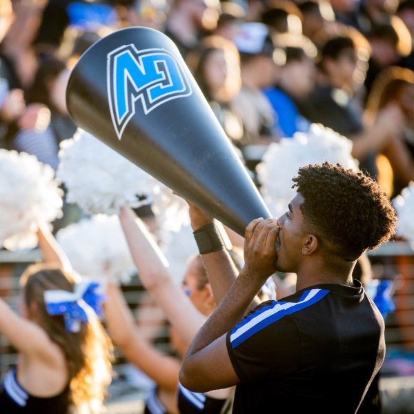 GVSU cheerleader yells into megaphone during Lakers football game
