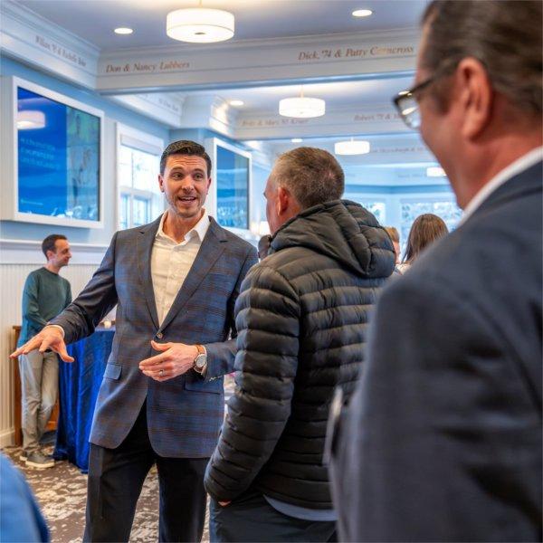 Mike Przydzial greets people in the Alumni House