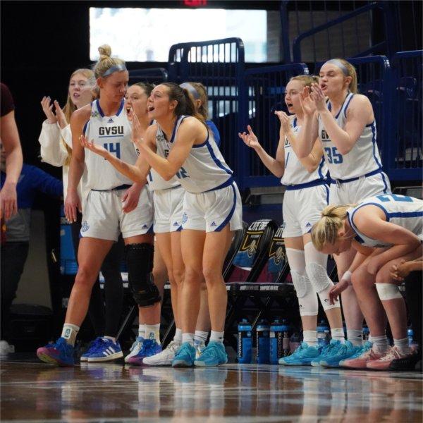 GVSU Women's Basketball Team cheers on their teammates from the bench.