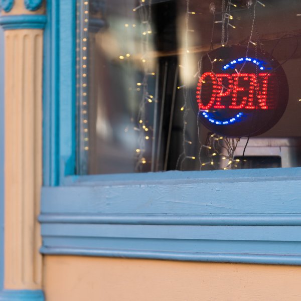 Storefront with an electronic sign that says open.