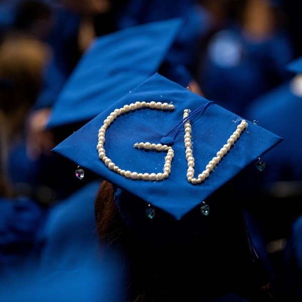 A blue mortarboard with the initials "GV" spelled out using pearls.