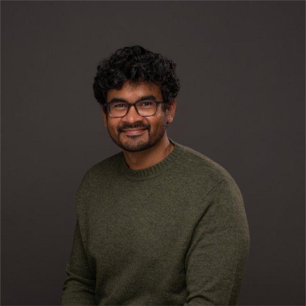 Sanjivan Manoharan in olive sweater