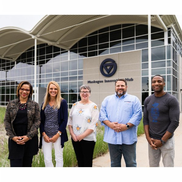 Finalists stand in front of the Muskegon Innovation Hub.
