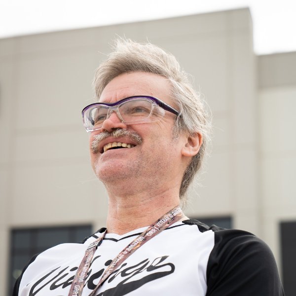 headshot of Mark Sessions outside an Amazon fulfillment center