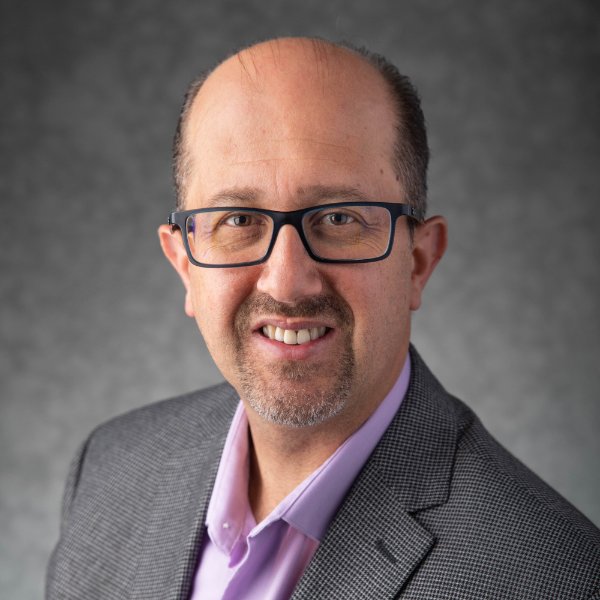 Majd Al-Mallah smiles in a posed photo.