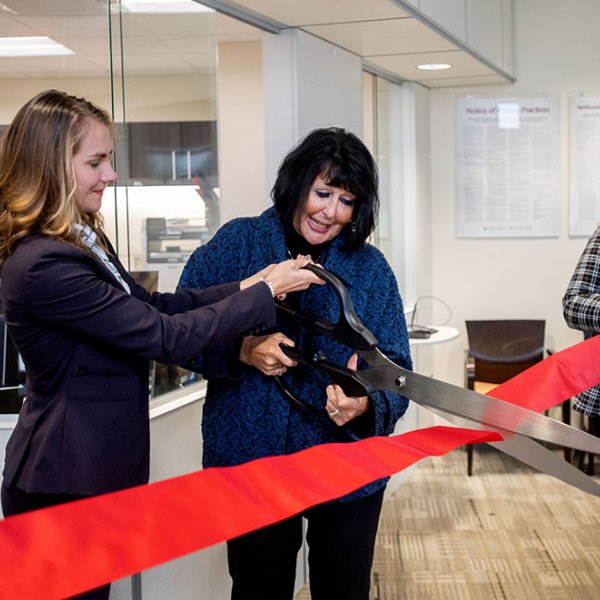 Cutting a celebratory ribbon are, from left, Dr. Kristen Woods, president of Trinity Health Medical Group; GVSU President Philomena V. Mantella; and Kate Harmon, GVSU acting assistant vice president for Student Affairs.