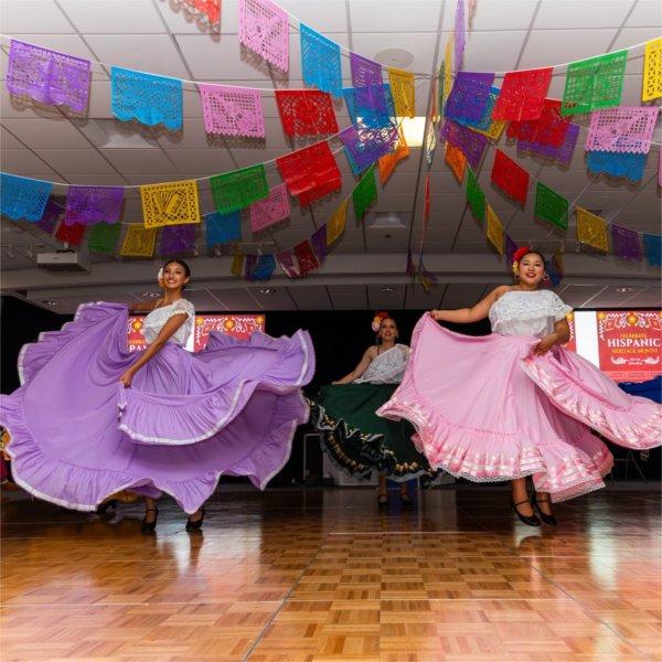 students in colorful Hispanic dresses