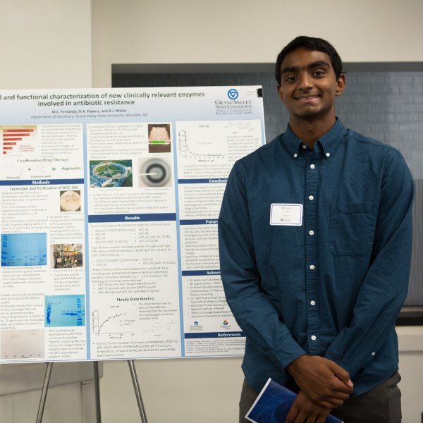 Micah Fernando pictured in front of his research poster