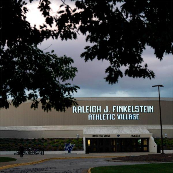 A GVSU building with the words Raleigh J. Finkelstein Athletic Village. The GV logo is also on and in front of the building.
