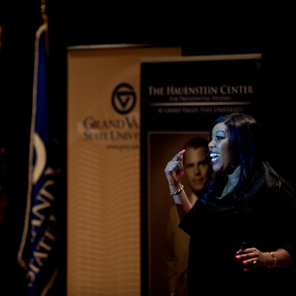 Graduate speaks to audience during presentation for Peter C. Cook Leadership Academy