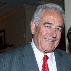 A man smiles in a posed shot.