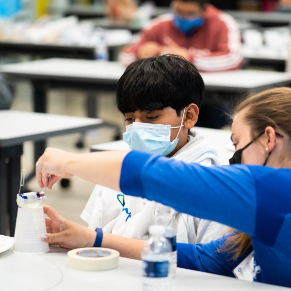 Instructor leads camper through building a motor
