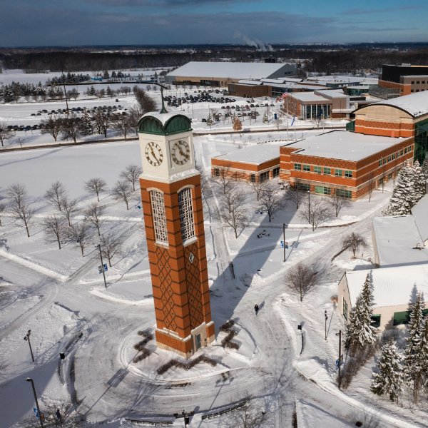 Drone photo of Allendale campus with clock tower at center and lots of sidewalks
