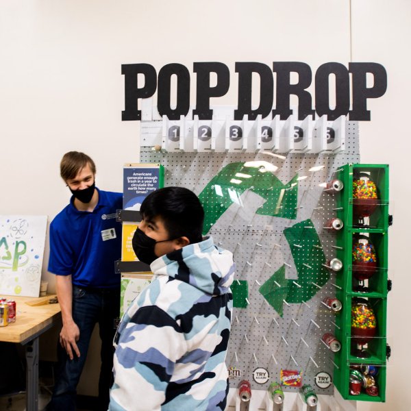 pop drop machine in background, young student laughing, GVSU student in background