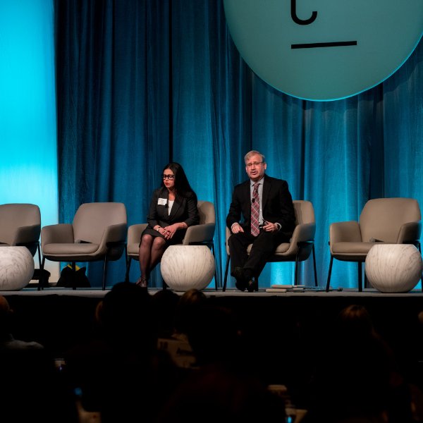 Seidman economics faculty members Kuhelika De, left, and Paul Isely discuss the economic forecast at the Grand Rapids Chamber's annual meeting at the DeVos Place February 2.