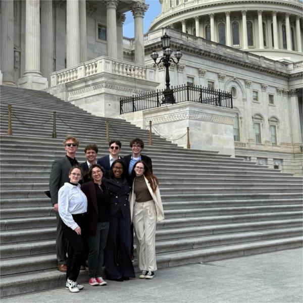 eight students standing in front of Capitol building steps