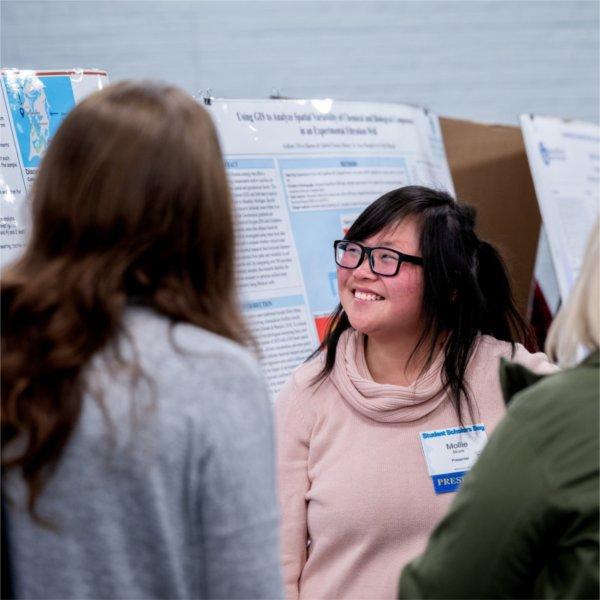 Student answers questions from visitors during her presentation at Student Scholars Day.