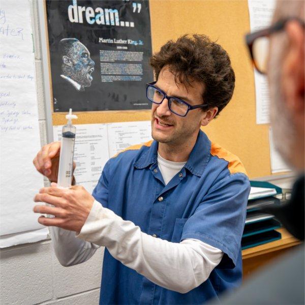 A student in the Bellamy Creek Program demonstrates his experiment during a class.