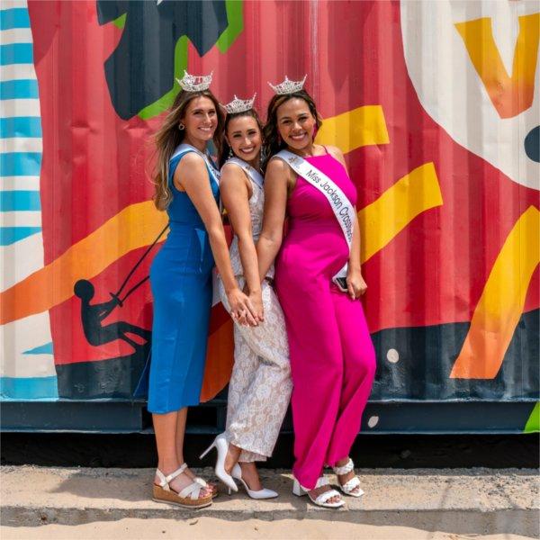 Natalee Urbon, Lauren Mroczek, and Payton Perry-Radcliffe pose for a photo as they prepare to compete for Miss Michigan.