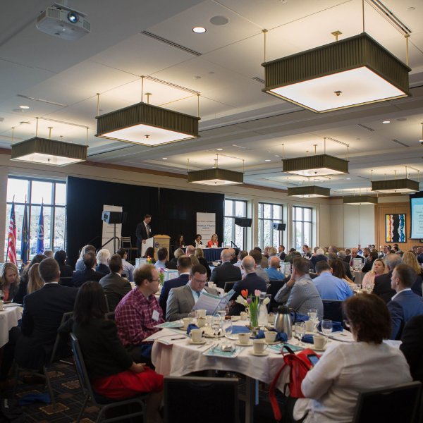 room of round tables with people seated at nearly every chair; L. William Seidman Center, World Trade Week conference from 2018