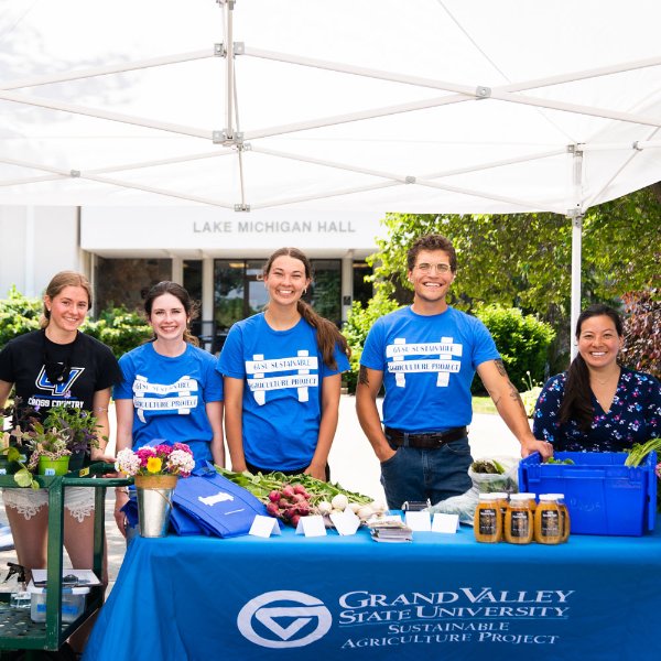 Several people help sell produce at the GVSU Farm Stand