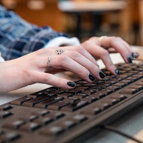 A person typing on a keyboard