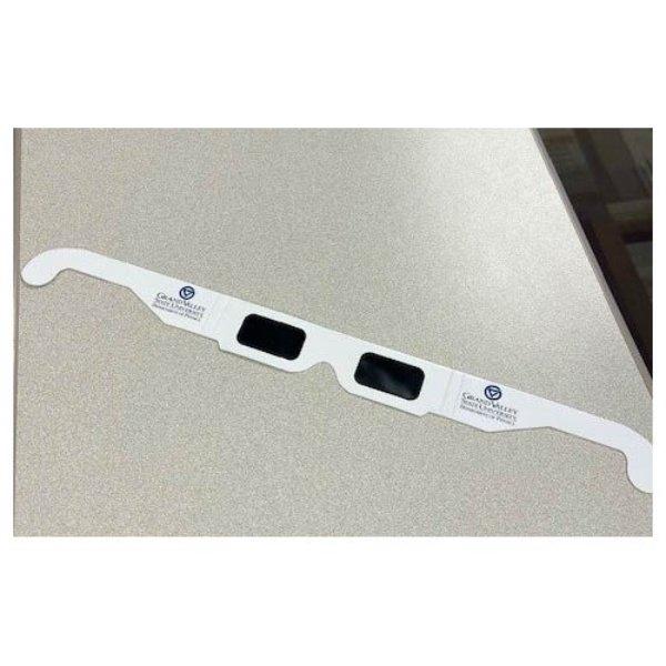 Special eclipse-viewing glasses with the GVSU Physics Department logo sit on a table.