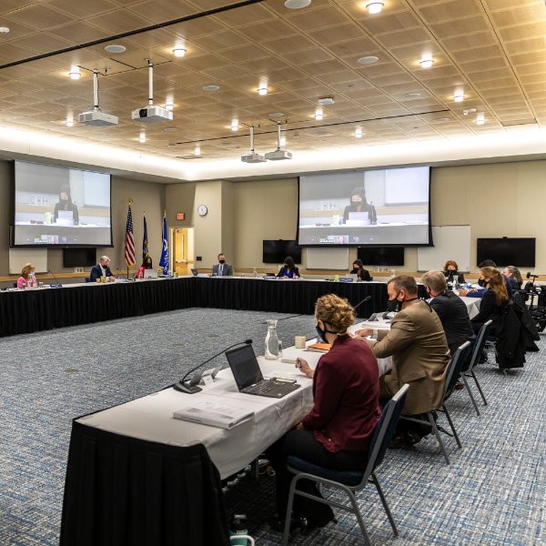 Board of Trustees members sitting around a table.