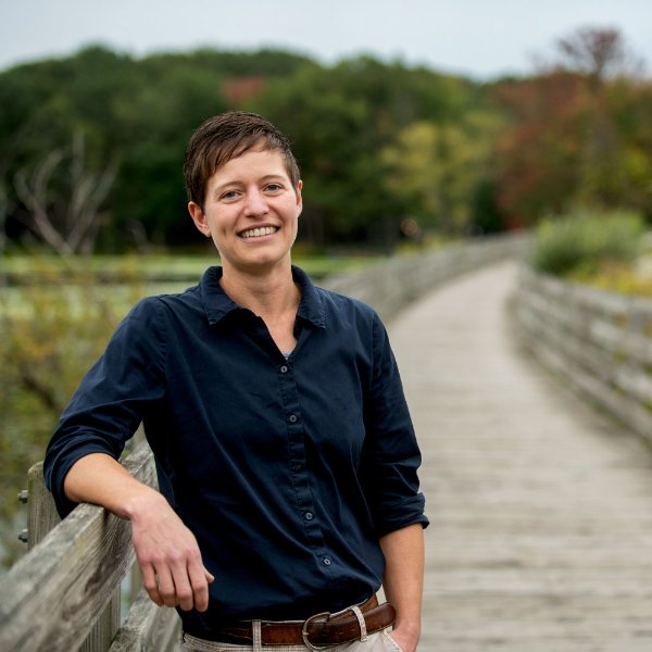 Amanda Buday stands on a boardwalk near water.