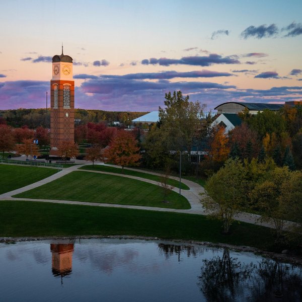 sunset view of Cook Carillon Tower in foreground reflecting on Zumberge Pond.