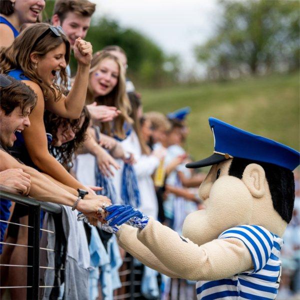 Louie the Laker greets fans in the stands during a football game at Lubbers Stadium.