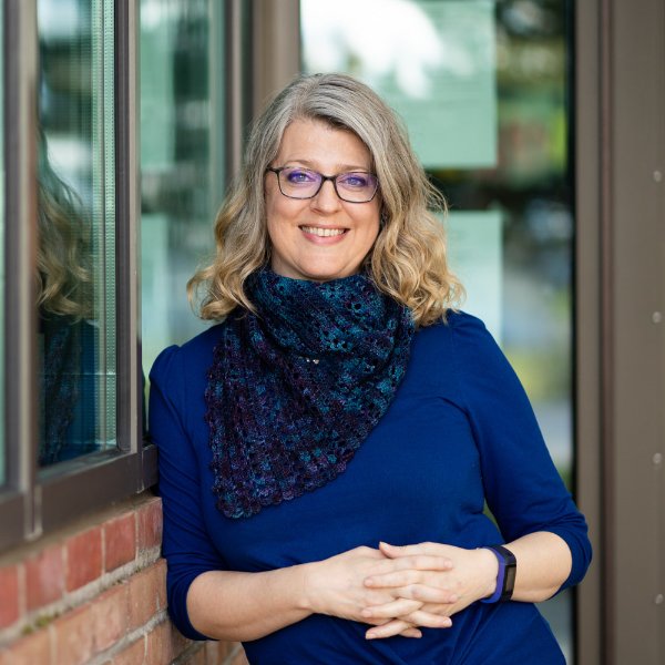 headshot: Darla Eimers standing outside with blue sweater and blue scarf