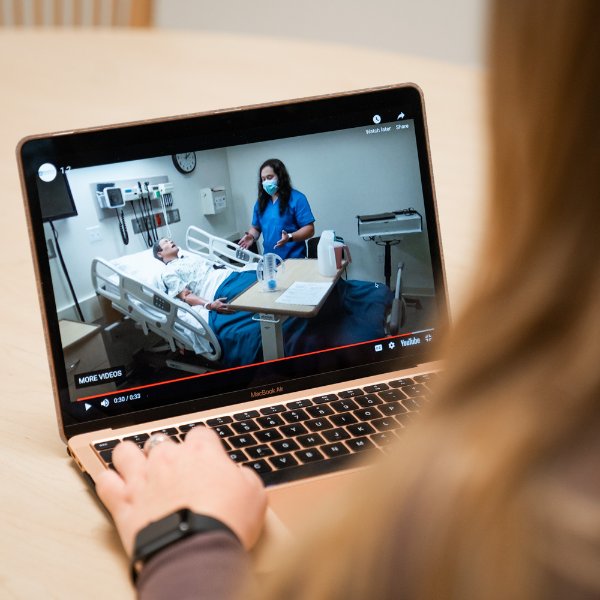 Computer screen showing Doug Ayers with a mannequin in the Simulation Center