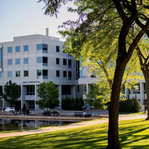 Zumberge Hall as seen in front of the pond with tree on right hand side