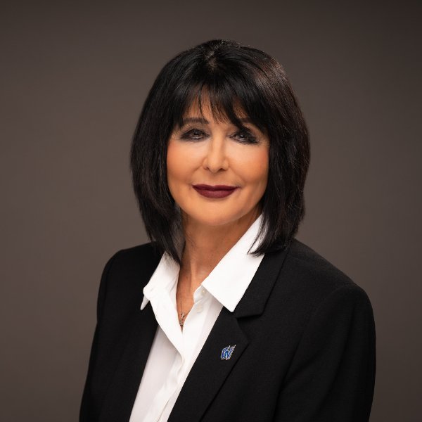 headshot of President Mantella, in black jacket with small GV lapel pin