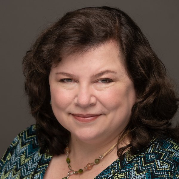 A person smiles in a posed portrait.