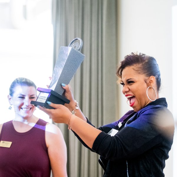 Zaneta Adams holding award.