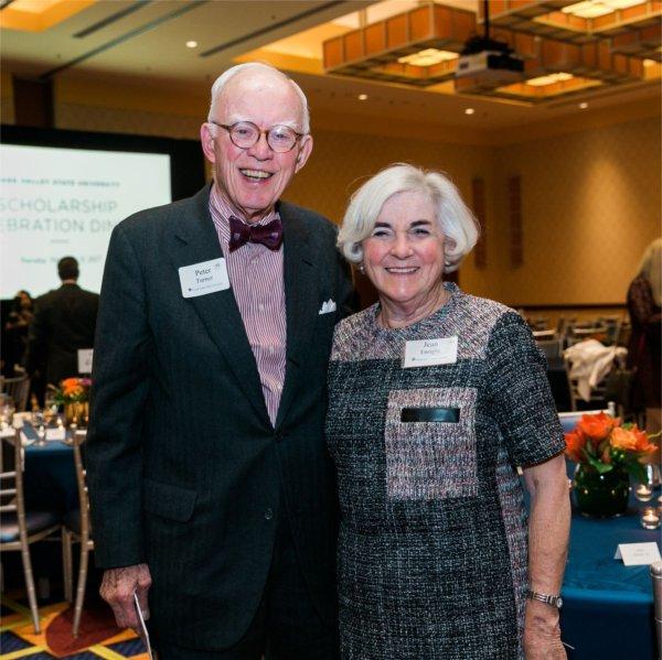 Peter Turner and Jean Enright standing with arms around each other at the Scholarship Dinner