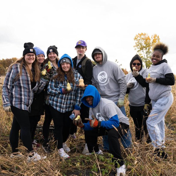 nine students posing outdoors at the SAP during Make a Difference Day